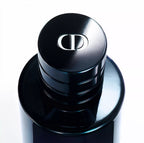Close-up of a black cosmetic container with a brand logo on a white background