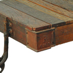 50" Brown and Black Solid Wood and Iron Distressed Wheel Coffee Table