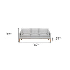 87" Gray Leather Sofa And Toss Pillows With Brown Legs