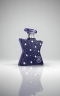 Blue perfume bottle with star patterns and Bond No. 9 NYC logo on a white background