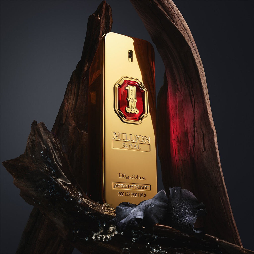Gold perfume bottle with red cap on a dark background
